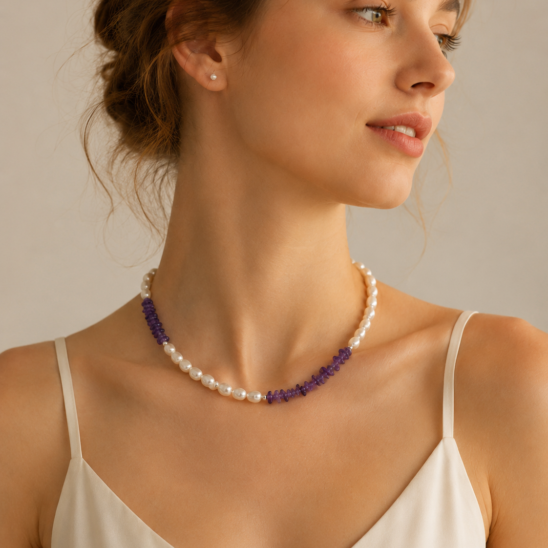 Model wearing Freshwater Pearl Amethyst Asymmetric Necklace with ivory camisole and modern pearl styling