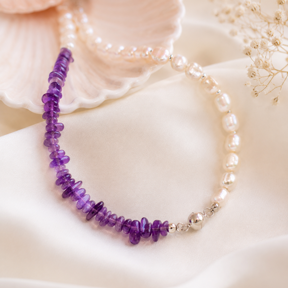 Close-up of irregular freshwater pearls, violet amethyst beads, and sterling silver details in Freshwater Pearl Amethyst Asymmetric Necklace