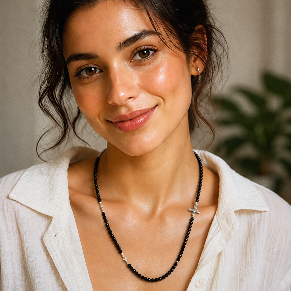 Model wearing Black Spinel Sterling Silver Cross Necklace with white linen summer outfit