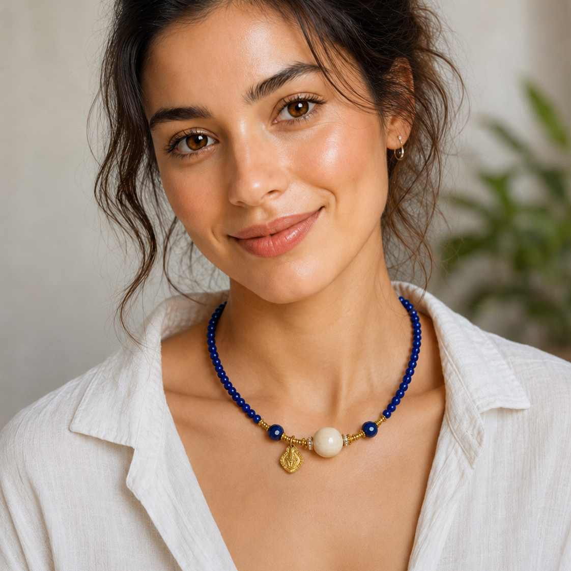 Model wearing Lapis Lazuli Beaded Necklace with Gold-Plated Sterling Silver and a white linen shirt