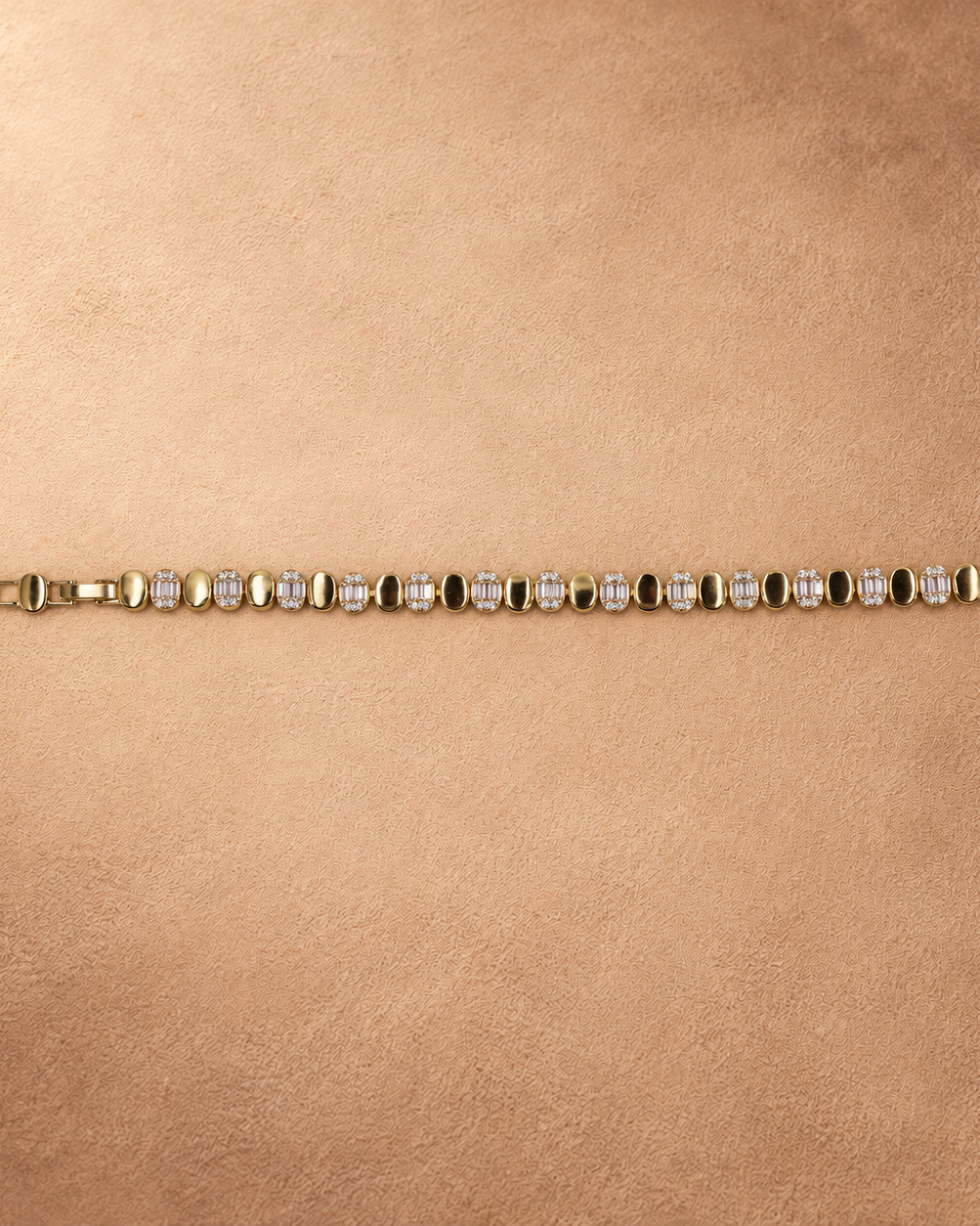 Full-length view of the Dalia bracelet laid straight with the clasp open and alternating polished oval links and clear accents.