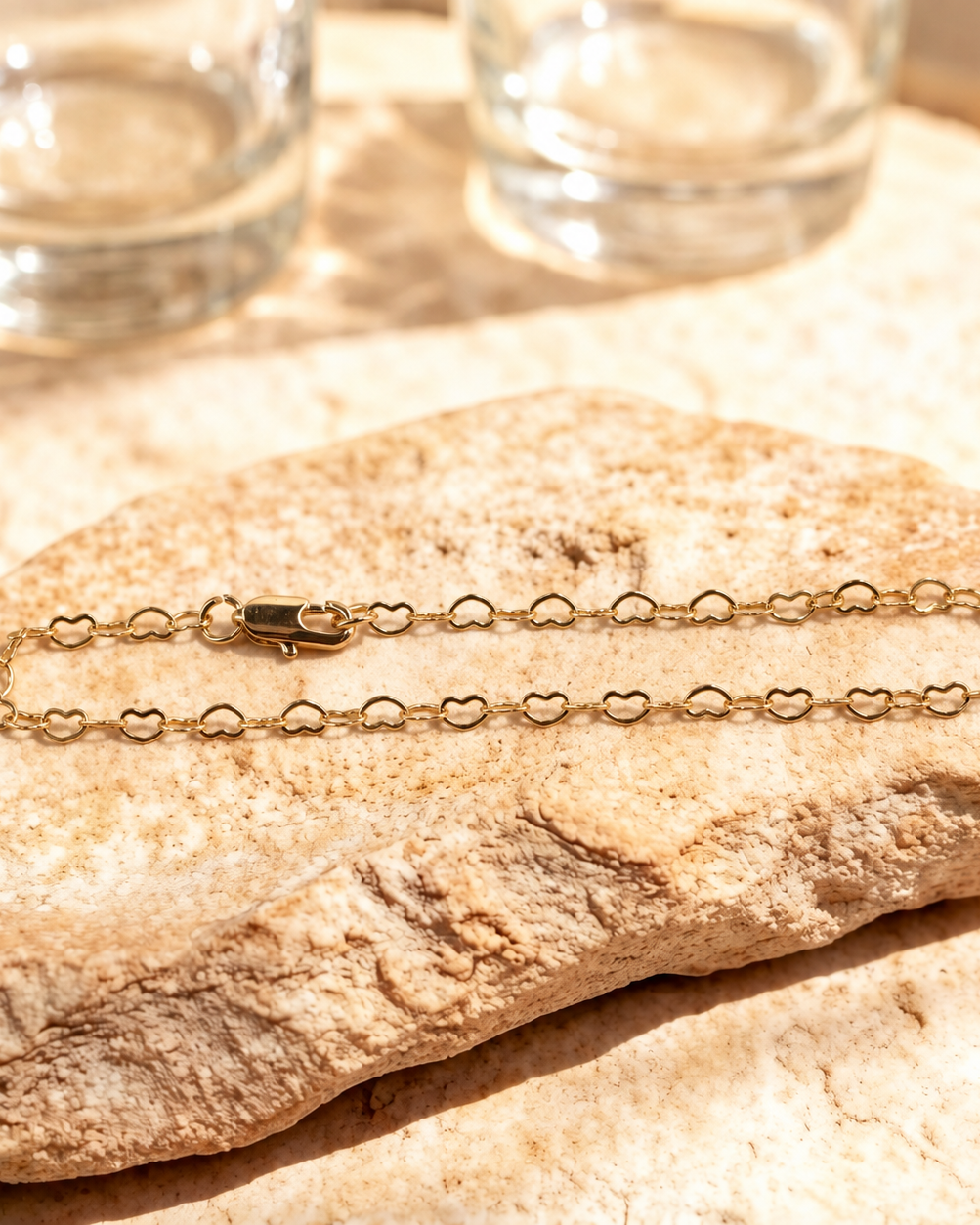 Esme 14K gold-plated steel bracelet arranged in a long oval, showing open heart links and a polished lobster clasp.
