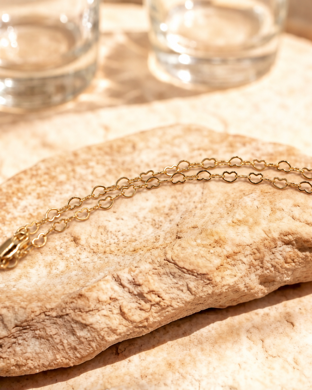 Closer view of Esme heart link bracelet in a curved arrangement, with the clasp at the left.