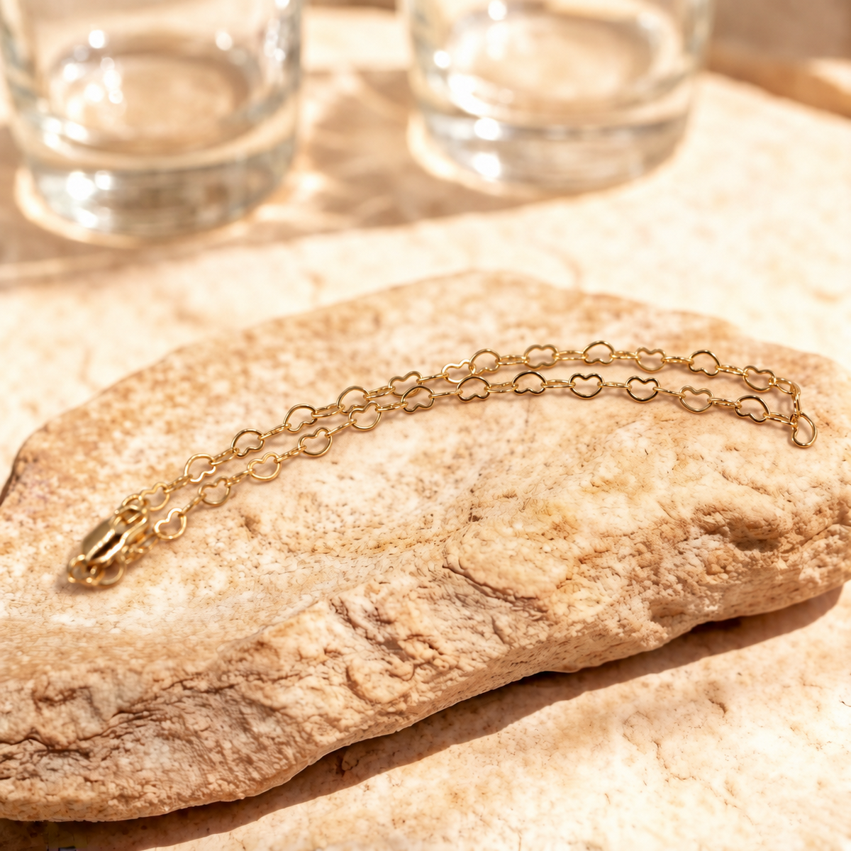 Closer view of Esme heart link bracelet in a curved arrangement, with the clasp at the left.