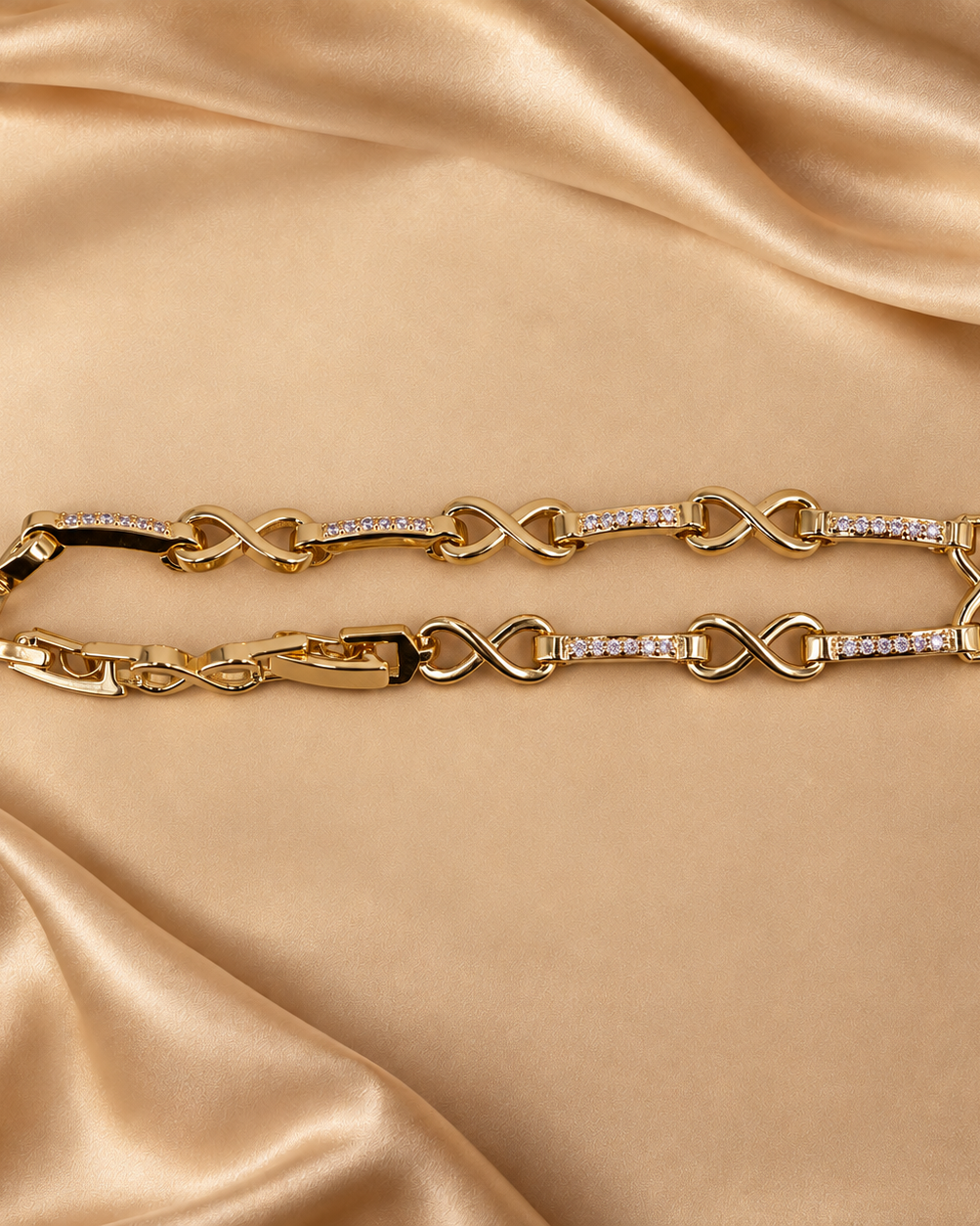 Evera infinity link bracelet arranged in a narrow oval, showing polished figure-eight links and clear-accent bars.