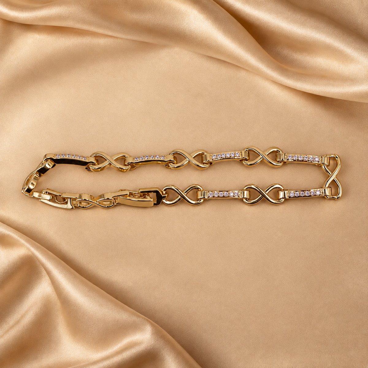 Evera infinity link bracelet arranged in a narrow oval, showing polished figure-eight links and clear-accent bars.