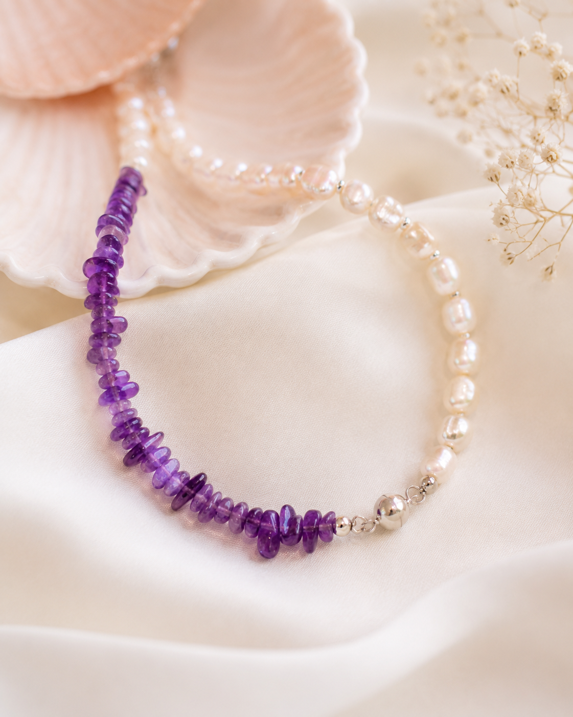 Close-up of irregular freshwater pearls, violet amethyst beads, and sterling silver details in Freshwater Pearl Amethyst Asymmetric Necklace