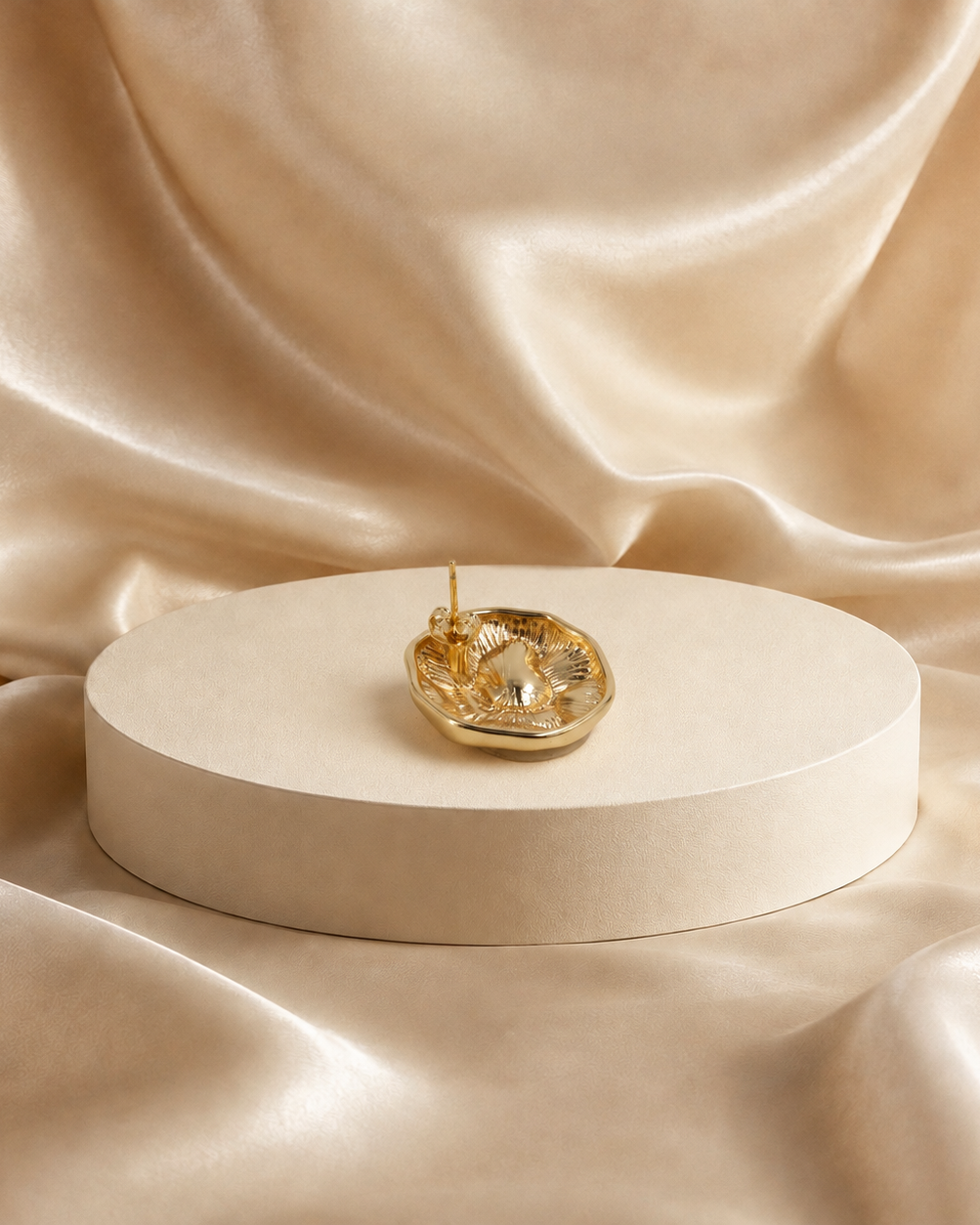 Back view of Onda sculptural stud earring, showing its recessed reverse and post attachment.
