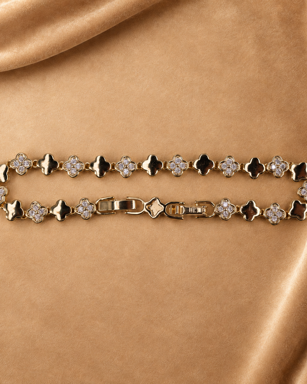 Sylvie 14K gold-plated steel bracelet arranged in an oval, with polished clover links alternating with clear-accent clovers.
