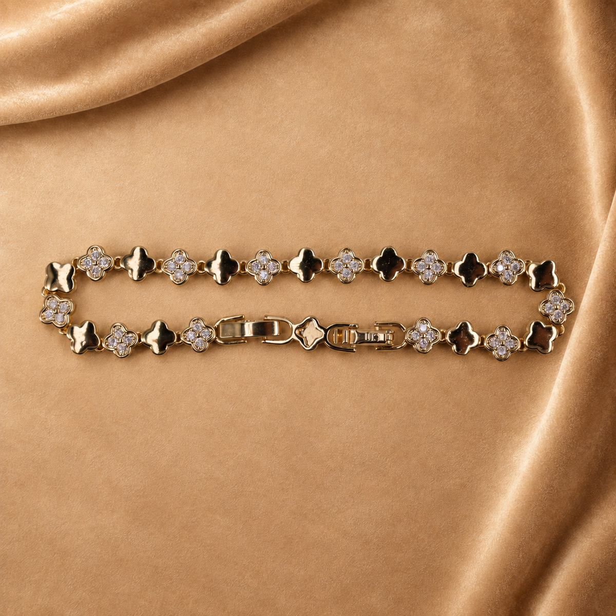 Sylvie 14K gold-plated steel bracelet arranged in an oval, with polished clover links alternating with clear-accent clovers.