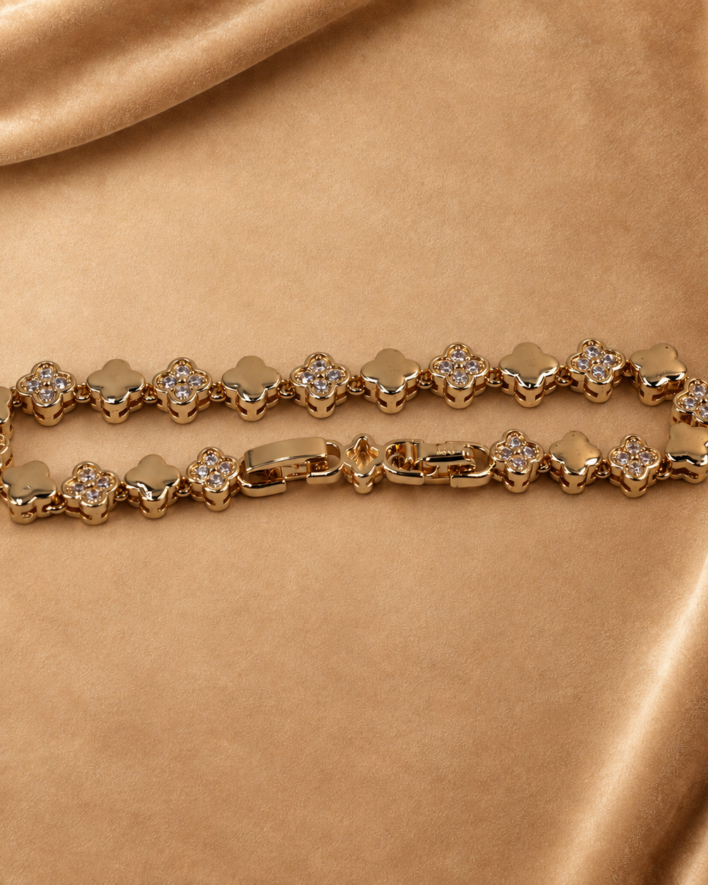 Angled close view of Sylvie clover bracelet, showing raised links, clear accents and the polished clasp.