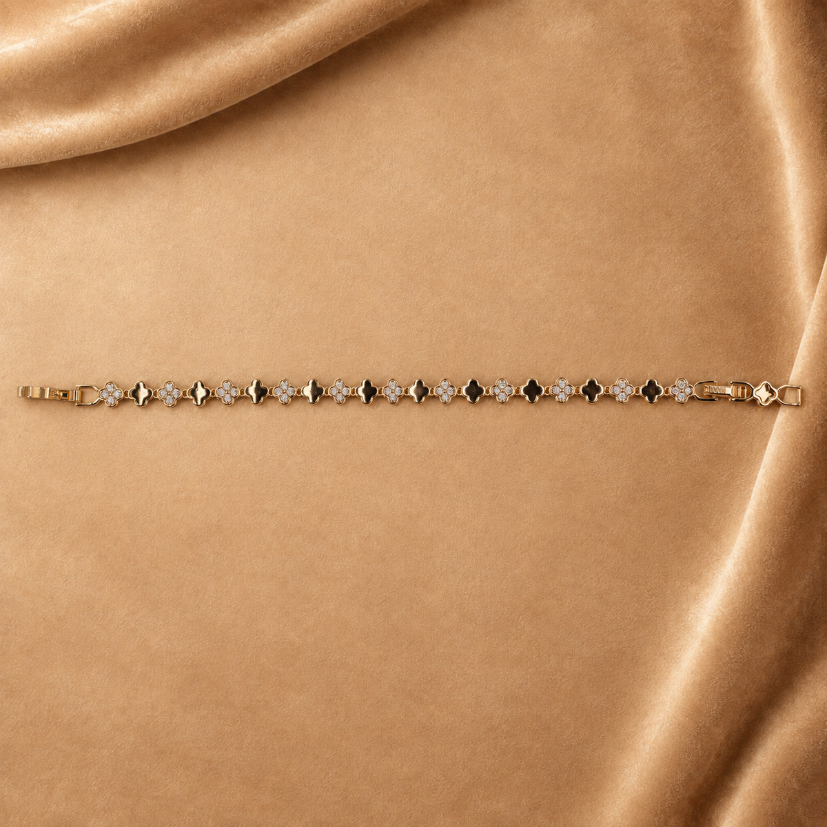Sylvie gold-plated clover link bracelet laid straight with the clasp open, showing the full repeating pattern.