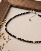 Close-up of brilliant-cut black spinel beads and sterling silver accents in Faceted Black Spinel Sterling Silver Long Necklace