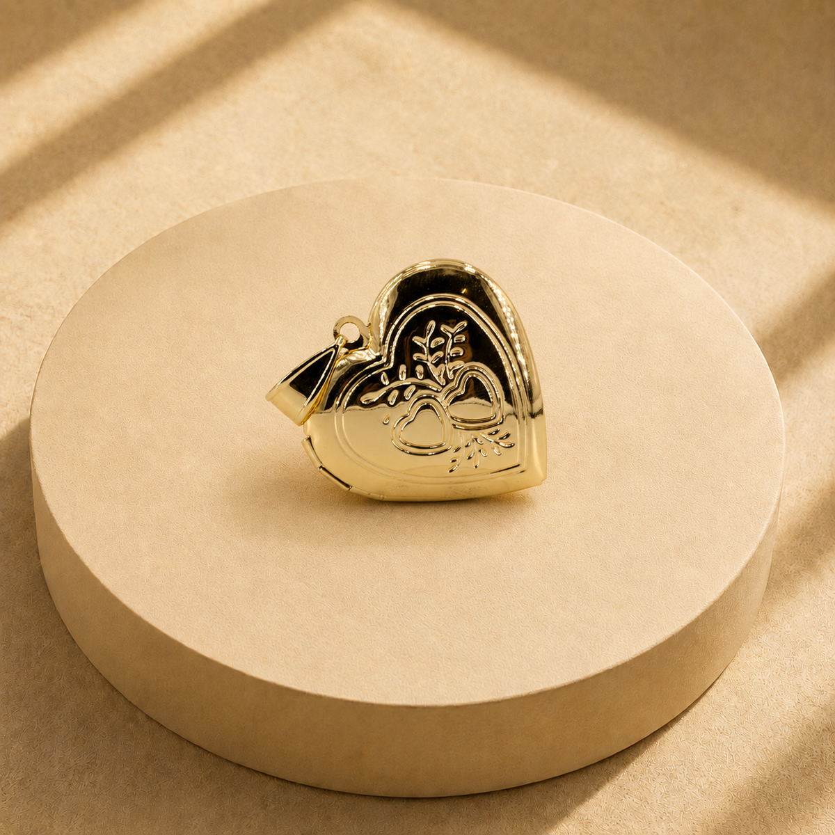 Angled front view of the Adora heart pendant showing the heart and leaf motif, polished border and bail.