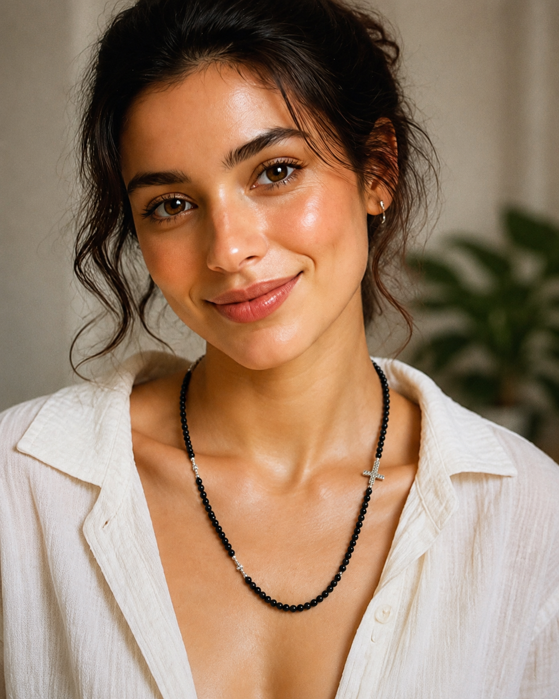 Model wearing Black Spinel Sterling Silver Cross Necklace with white linen summer outfit