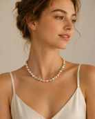 Model wearing Celeste Pastel Shell Pearl Charm Necklace with soft feminine pearl styling
