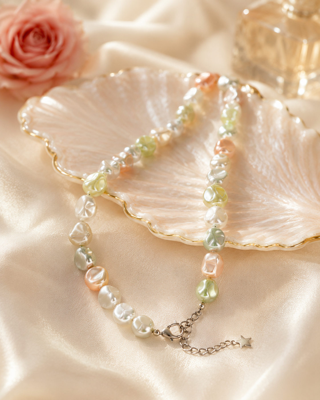 Close-up of irregular pastel shell pearls and silver-tone star charm in Celeste Pastel Shell Pearl Charm Necklace
