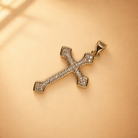 Clara 14K gold-plated steel cross pendant, showing clear accents, flared ends and a polished bail.
