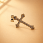 Clara cross pendant at an alternate angle, showing the rows of clear accents and smooth gold-plated border.