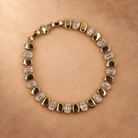 Dalia gold-plated bracelet arranged in an oval, with alternating polished oval links and clear accents.