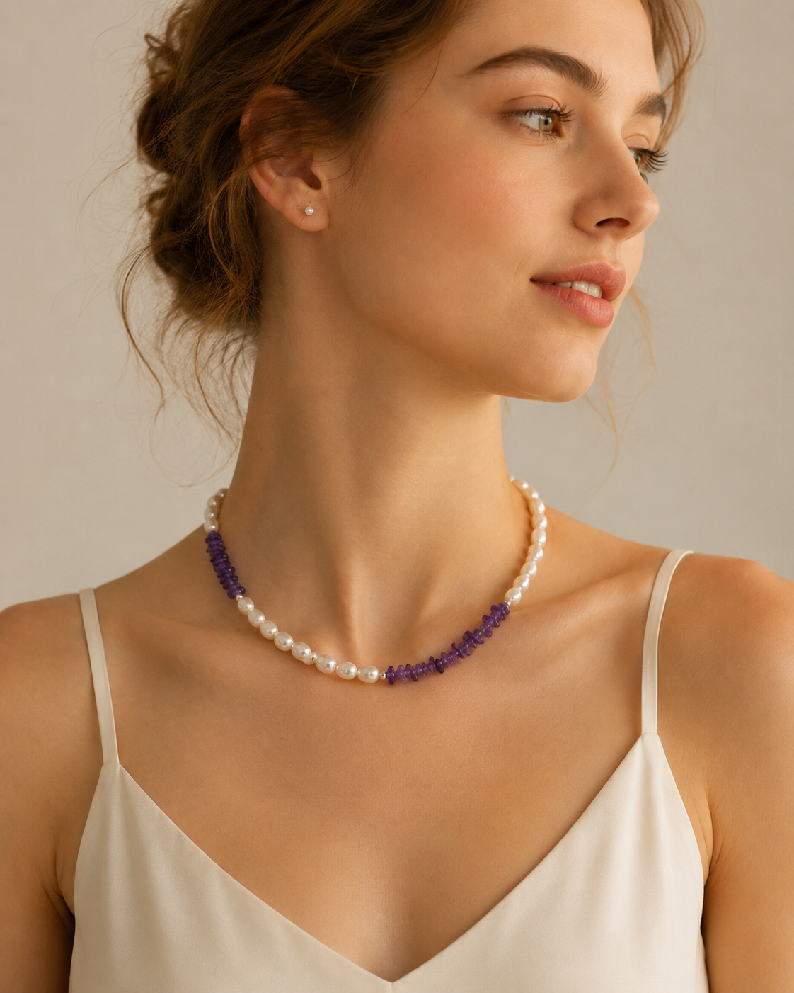 Model wearing Freshwater Pearl Amethyst Asymmetric Necklace with ivory camisole and modern pearl styling