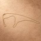 Angled full view of Linea gold-plated box chain necklace, showing its slender profile and small square links.