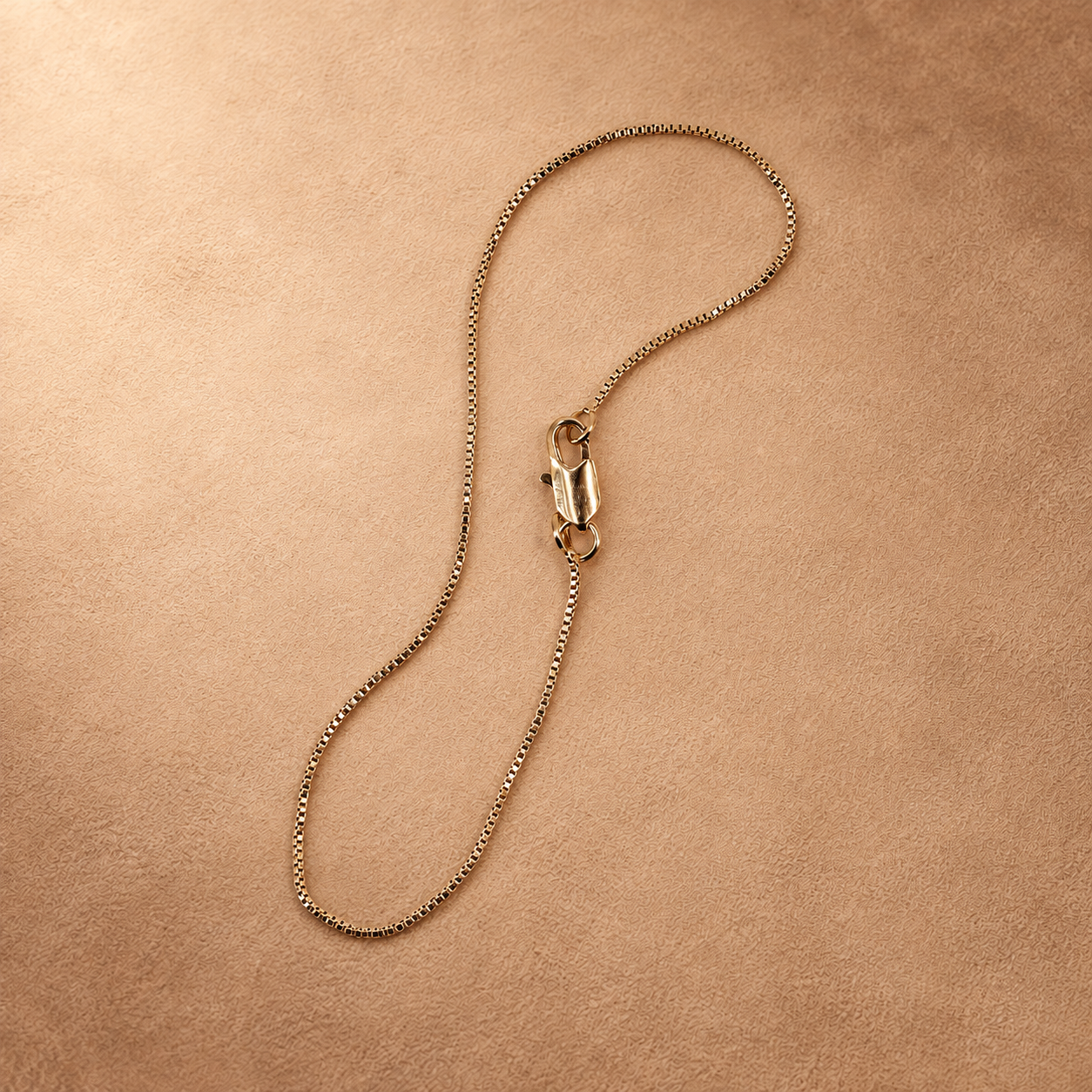Linea bracelet in a looped arrangement, showing the small square chain links and polished lobster clasp.