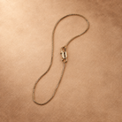 Linea bracelet in a looped arrangement, showing the small square chain links and polished lobster clasp.