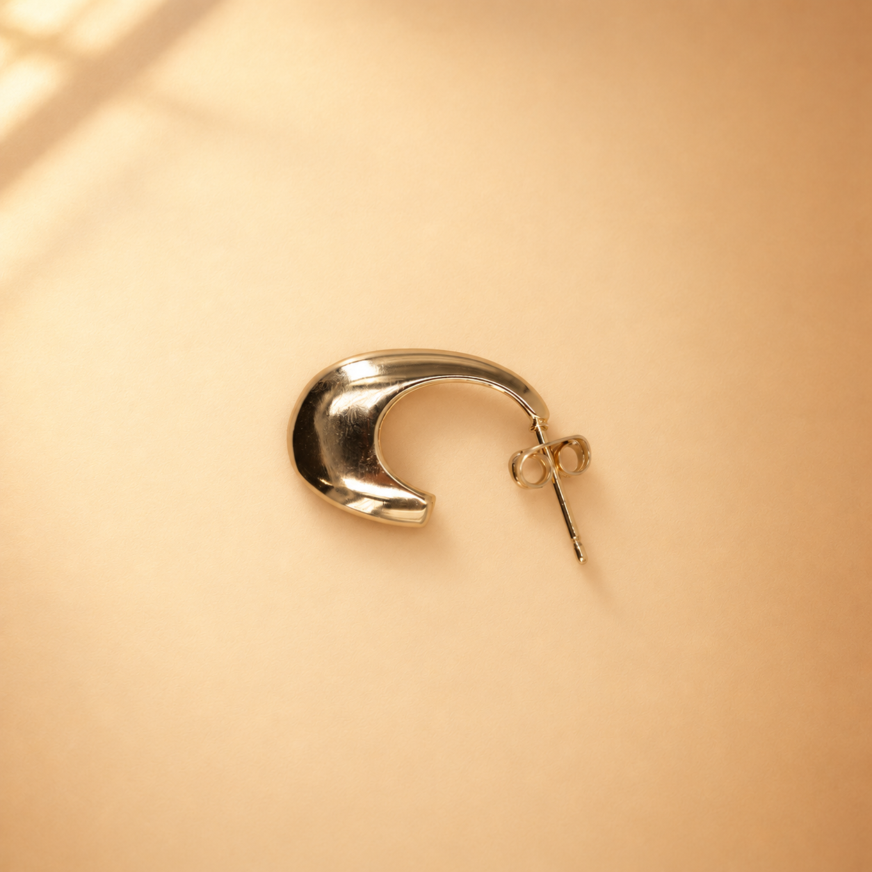 Reverse view of Lune crescent hoop earring showing the recessed back, straight post and butterfly-style push back.