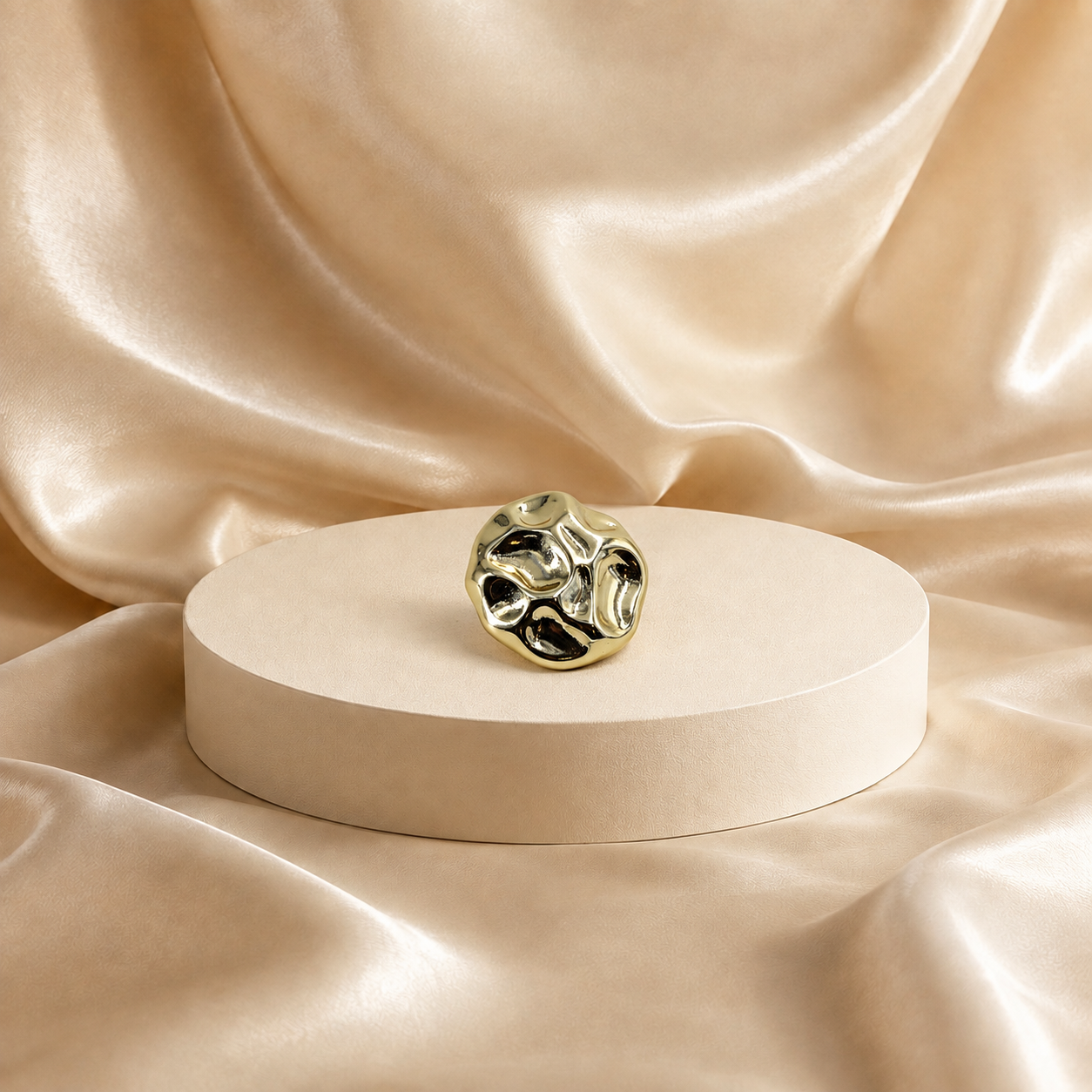 Front view of Onda 14K gold-plated steel stud earring, showing an irregular rounded outline and rippled polished surface.