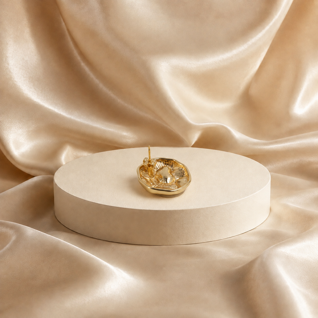 Back view of Onda sculptural stud earring, showing its recessed reverse and post attachment.