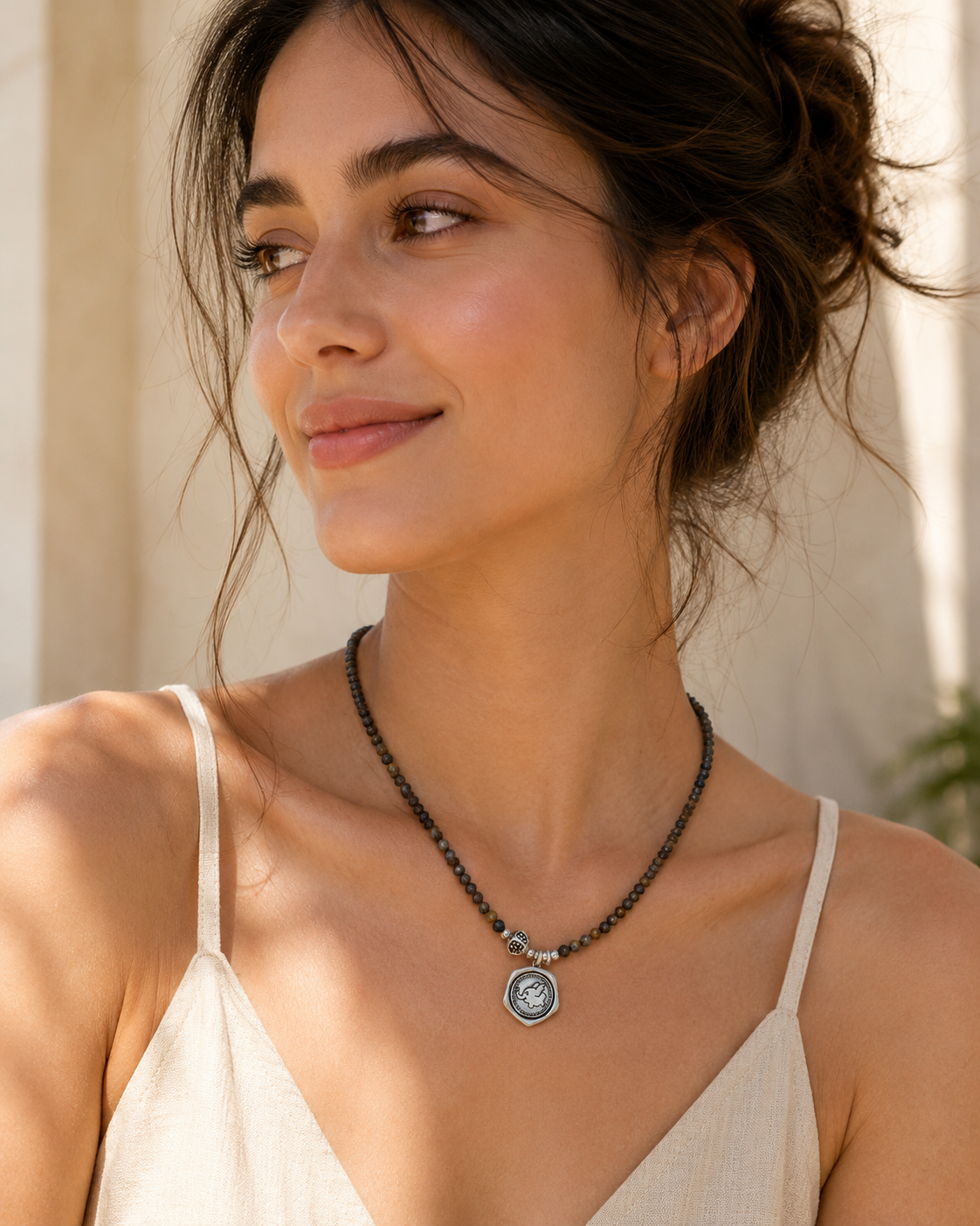 Model wearing Sahara Pietersite Sterling Silver Pendant Necklace with relaxed summer outfit