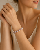 Model wearing Serena Iridescent Freshwater Pearl Bracelet with soft romantic styling