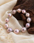 Close-up of irregular iridescent freshwater pearls and vintage Tai silver spacer beads in Serena Iridescent Freshwater Pearl Bracelet