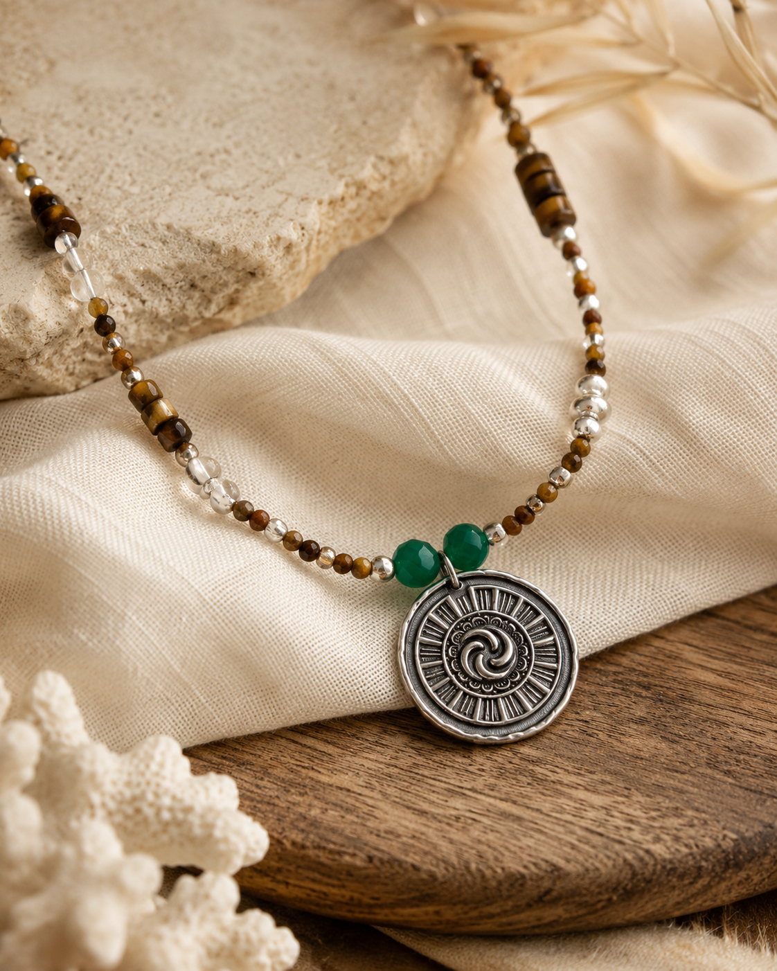 Close-up of tiger’s eye beads, clear quartz, green accents, and sterling silver pendant in Solstice Tiger’s Eye Quartz Pendant Necklace