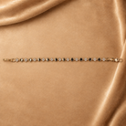Sylvie gold-plated clover link bracelet laid straight with the clasp open, showing the full repeating pattern.